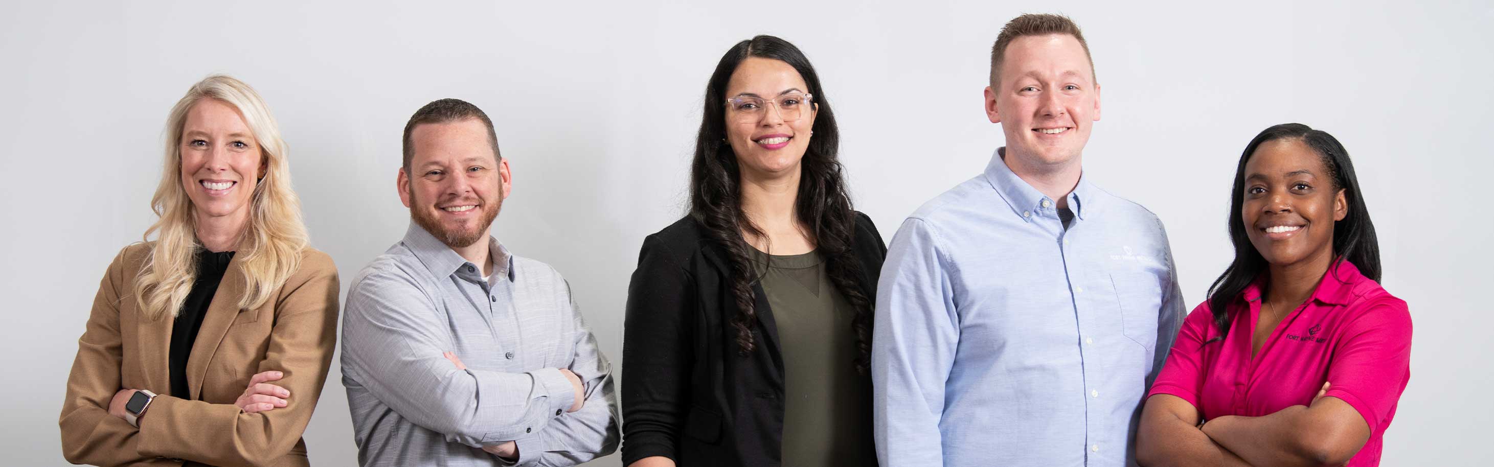 A group of Fort Wayne Metals workers stand together happily